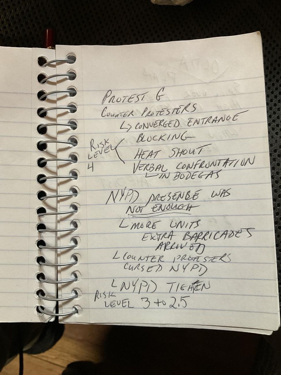 Handwritten field note recording protest and counter-protest convergence and a declining risk level