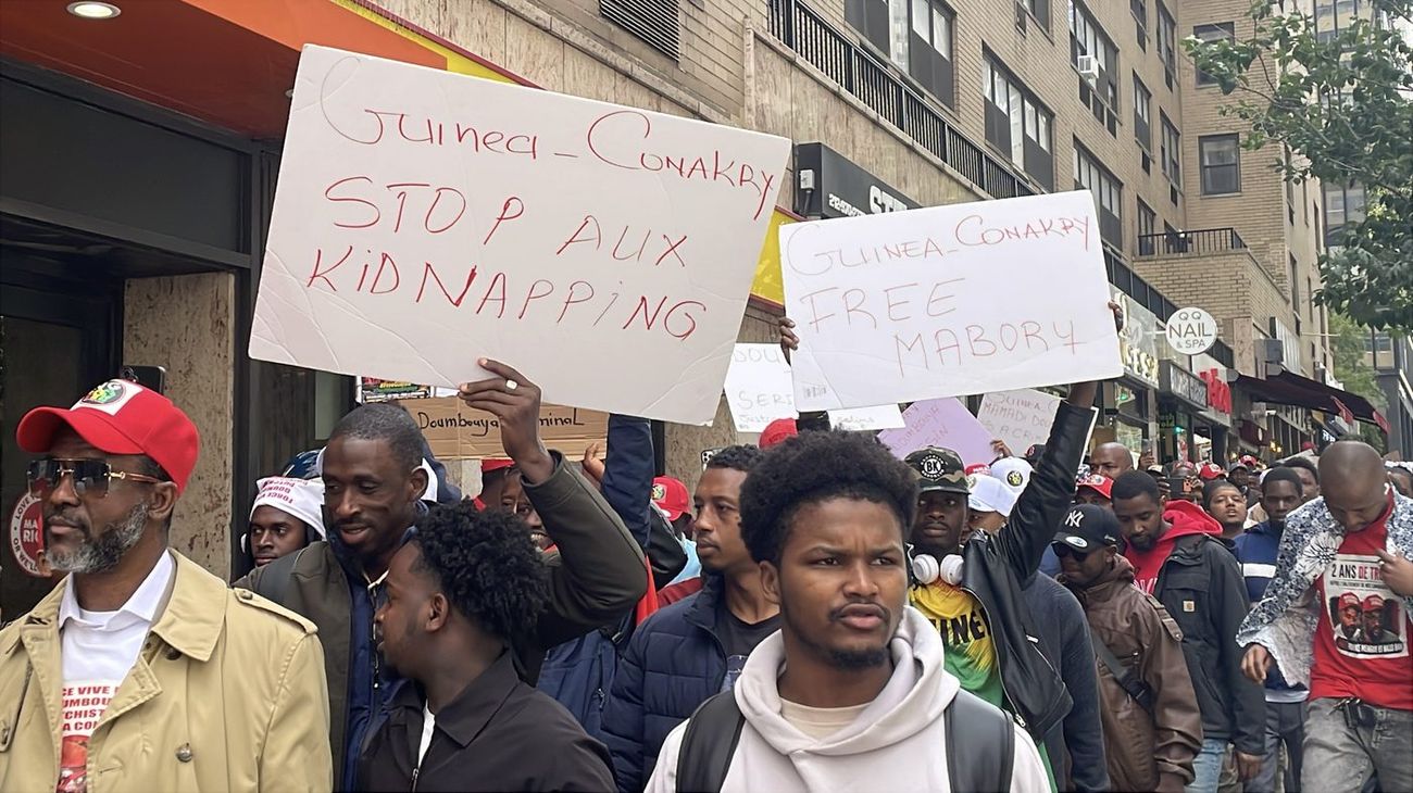 Marchers holding signs reading Stop Aux Kidnapping and Free Mabory, Guinea-Conakry