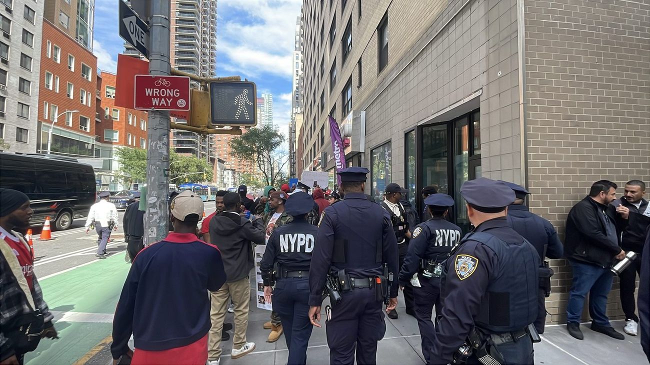 NYPD officers holding a sidewalk position near a protest gathering during UNGA 81